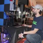 Commercial fees charged to lease virtual reality programs are one of the biggest expenses of his new business, Ethan Worthington says. He controls all the weird worlds that his customers experience from this computer.