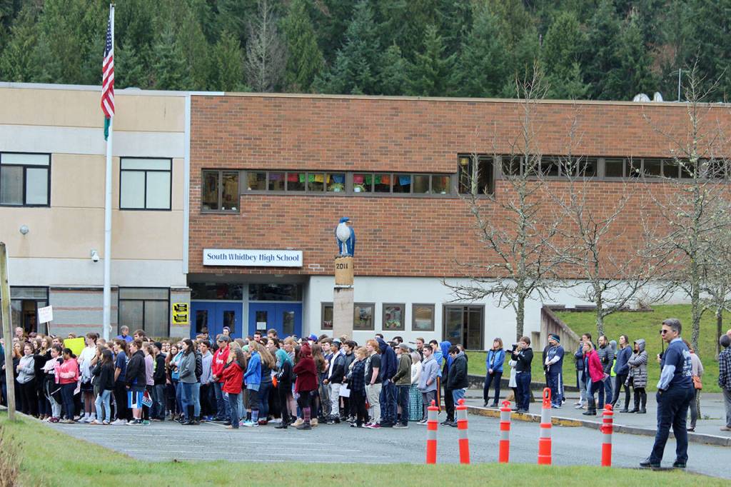South Whidbey students gather in front of the high school Wednesday morning as part of the national Enough school walkout. The campus was closed for the day as a safety precaution.