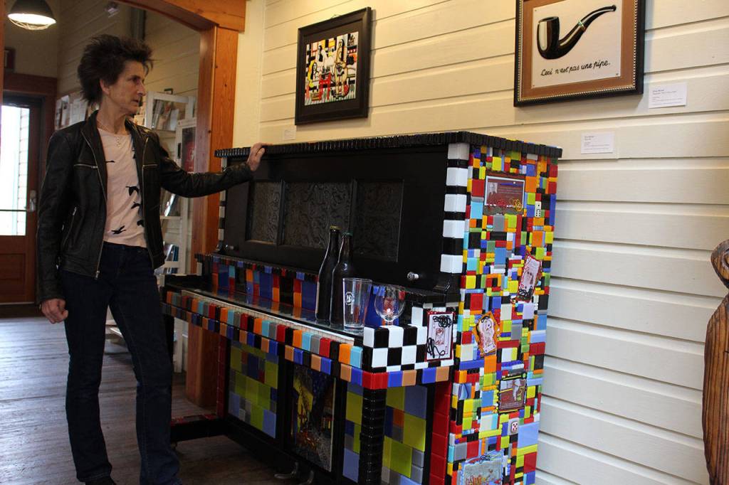 Artist Gina Michel with the 1923 Gulbransen Player Piano she rescued in California and covered with more than 1,500 tiles that she hand makes in her studio. Photos by Patricia Guthrie/Whidbey News-Group