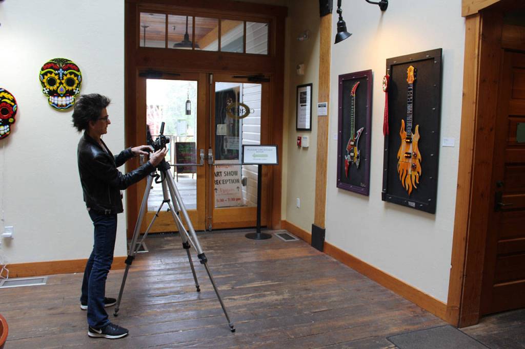 Gina Michel take photos of her exhibit Glassical Glass for promotional use. Her art show at Bayview Cash Store Hub Gallery is on display until April 15.