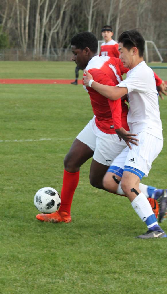 Michael Lux battles a Kings player for possession.(Photo by Jim Waller/Whidbey News Group)
