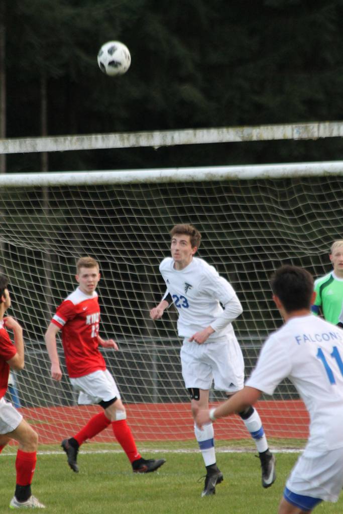 Lake Smith heads the ball out of trouble for the Falcons.(Photo by Jim Waller/Whidbey News Group)