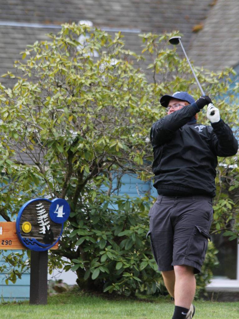 Brent DeWolf blasts a drive on No. 4.(Photo by Jim Waller/Whidbey News Group)