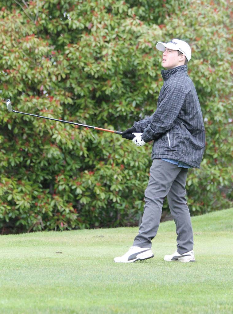 Noah Ratcliff follows the flight of his drive.(Photo by Jim Waller/Whidbey News Group)