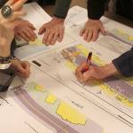 Langley residents look over different blueprints for redesigning Front Street parking at a city meeting. Divided into small groups, they wrote comments and also read suggestions.