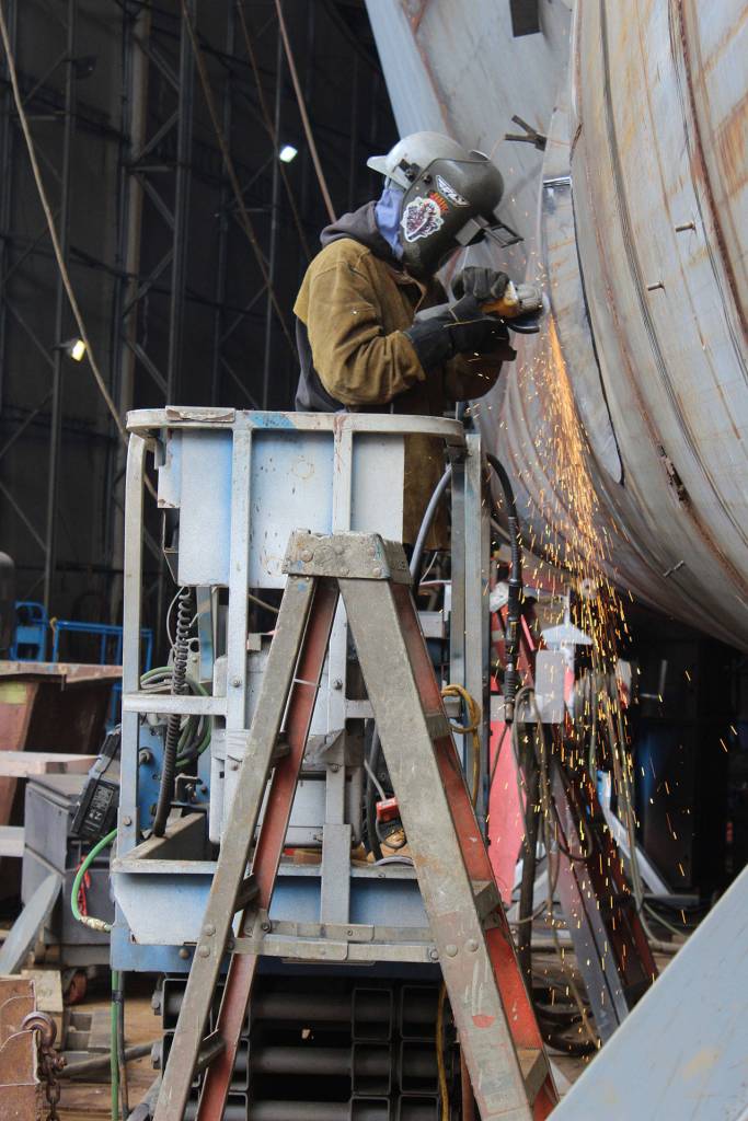 A welder works on the hull of a pocket cruise ship contracted to be built by Lindblad Expeditions/National Geographic, the second one built by Nichols Brothers. Theres usually four projects underway in different stages at the shipyard.