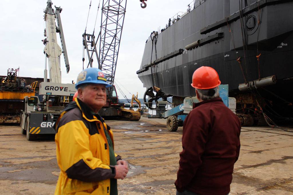 Matt Nichols, left, is the last of Nichols family working at Nichols Brothers Boat Builders in Freeland that started in 1964. Over the weekend, he watched the 189th vessel get launched after being constructed piece by piece behind the companys wooden fence.