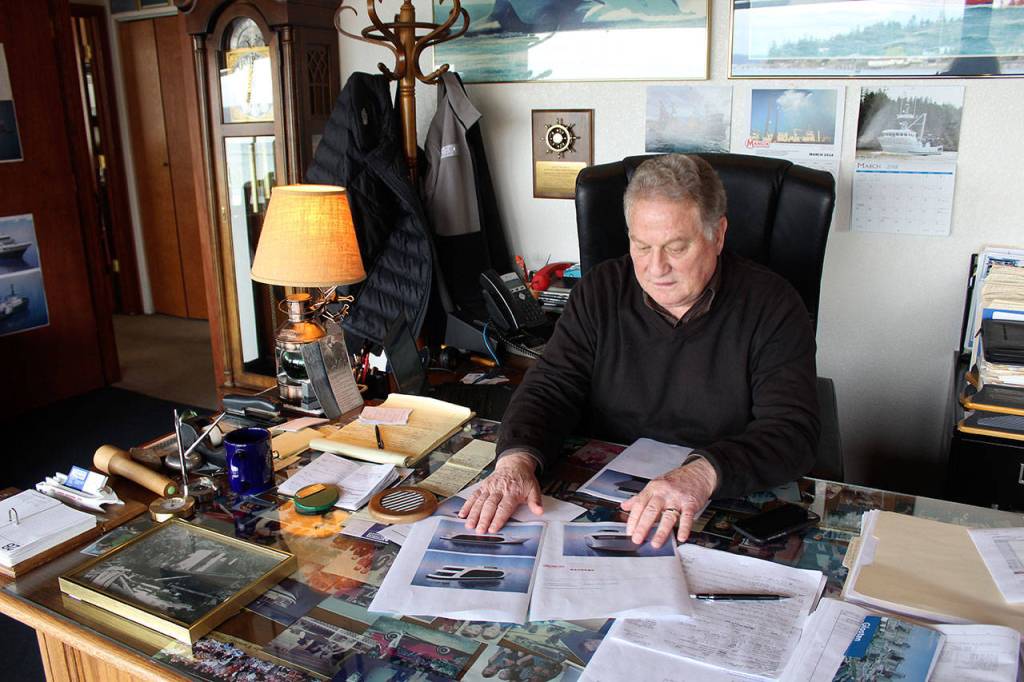 Matt Nichols, executive vice president of Nichols Brothers Boat Builders, looks over plans of a potential client at his office across from the shipyard. Nichols Brothers was sold in 2008 to Ice Floe and it retained the family name.
