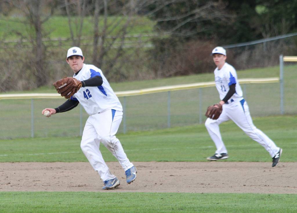 Third baseman Cameron Middlebrook sets up to throw across the diamond as shortstop Ethan Petty backs up the play.(Photo by Jim Waller/Whidbey News Group)