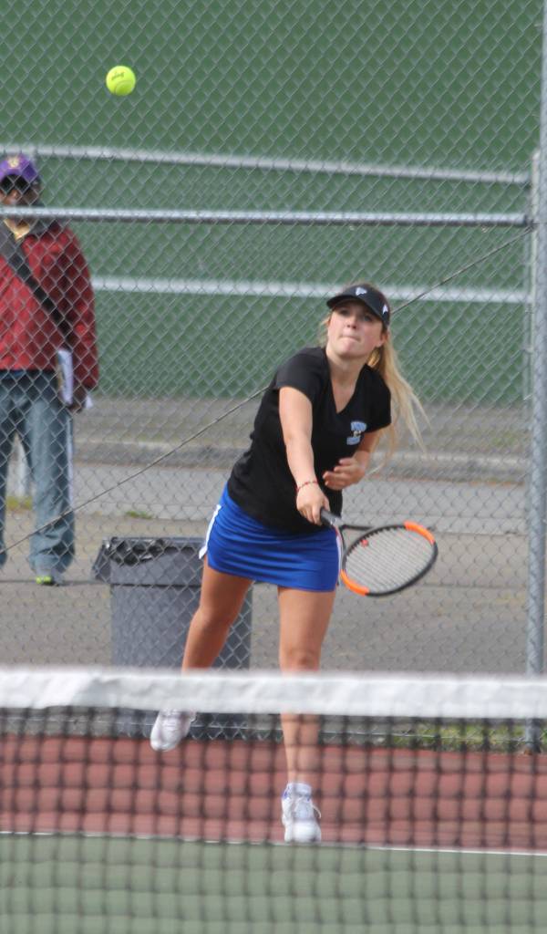 McKenna Kelley fires a serve against Oak Harbor. (Photo by Jim Waller/Whidbey News Group)