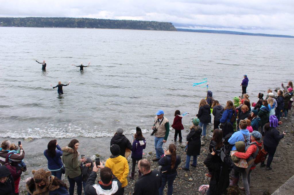 Three people in wet suits carried branches of blossoms out into deep water as the final welcoming tribute to the whales. The afternoon before, three gray whales scoured for ghost shrimp near this spot at high tide.