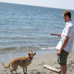 Judith Gorman submitted photo                                Orrin McClellan plays with his dog Koda-Bear at Useless Bay in 2009.
