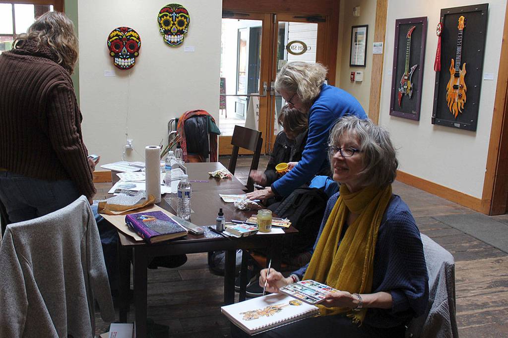 Whidbey Island Sketchers meet every Friday and sketch a variety of indoor locations, such as businesses, art shows and other interesting venues. When the weather gets nicer, they take their craft outdoors. No matter where they land, its always followed by wine time. Ask anyone, its a great group, says Barbara Barry, seated.