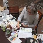 Whidbey Island Sketcher Debbie Hayes paints in the Bayview Cash Store during a recent Friday outing. Photo by Patricia Guthrie/Whidbey News Group