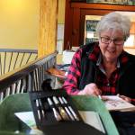 Pat Brookes finishes a small painting of other sketchers. She didnt ever draw before joining the Whidbey Island Sketchers two years ago. Now, she always has a journal to sketch in while traveling. Its so much more meaningful than taking dozens of photos, she says. Photos by Patricia Guthrie/Whidbey News Group