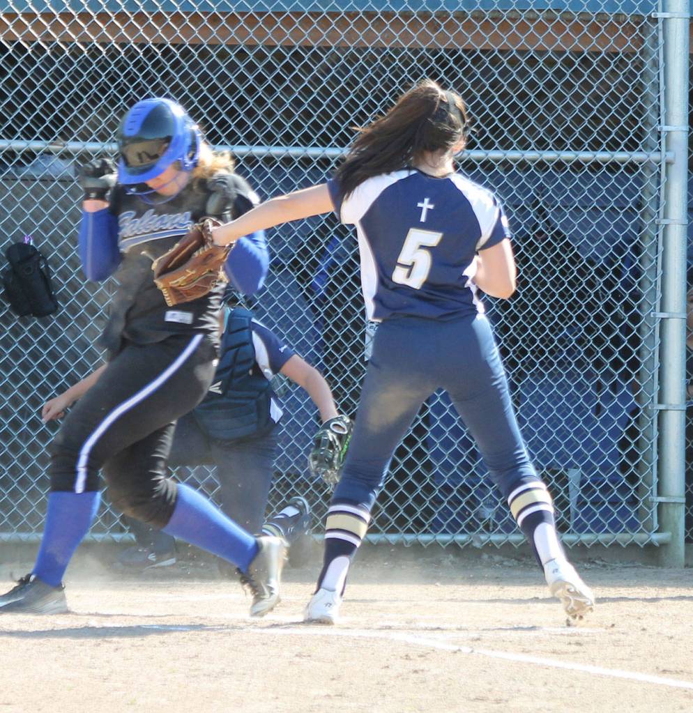 Bella Northrup is safe at home on a passed ball just ahead of the tag of CPC pitcher Cheyenne Nelson.(Photo by Jim Waller/Whidbey News Group)