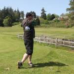 Holmes Harbor Golf Club operator Paul Lavin practices his swing near the 18th hole. Lavin is also a professional golfer available to teach.