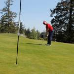 Marsha Coolidge lines up a putt Thursday as the Holmes Harbor Womens Golf Club got in the swing during its first outing of the season. Photo by Patricia Guthrie/Whidbey News Group