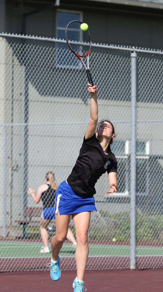 Alison Papritz serves in her win in first doubles.(Photo by John Fisken)