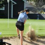 Emma Leggett blasts out of a trap.(Photo by Jim Waller/Whidbey News Group)