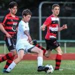 Aidan OBrien works to escape from a swarm of Mount Baker defenders. (Photo by Matt Simms)