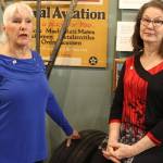 Writers Deborah Fisher (left) and Kellen Diamanti posed inside Oak Harbors PBY Naval Air Museum before leaving for ceremonies launching their book, Stamp of the Century. Photo by Patricia Guthrie/Whidbey News Group