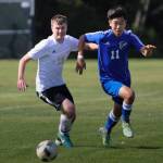 Graham Colar, right, races Meridians Manrag Gaday to the ball. (Photo by Matt Simms)