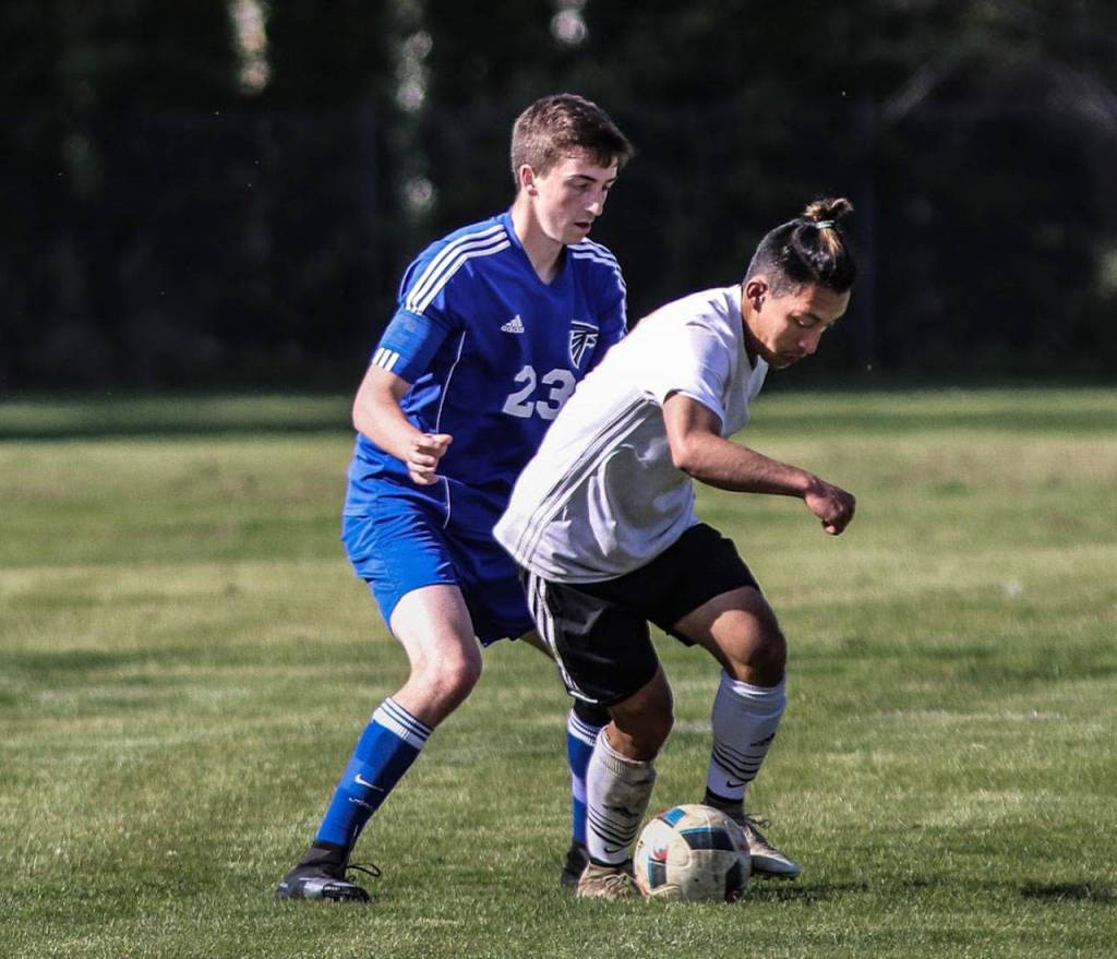 South Whidbey defender Lake Smith, left, hems in Merdians Carlos Padila-Solis.(Photo by Matt Simms)