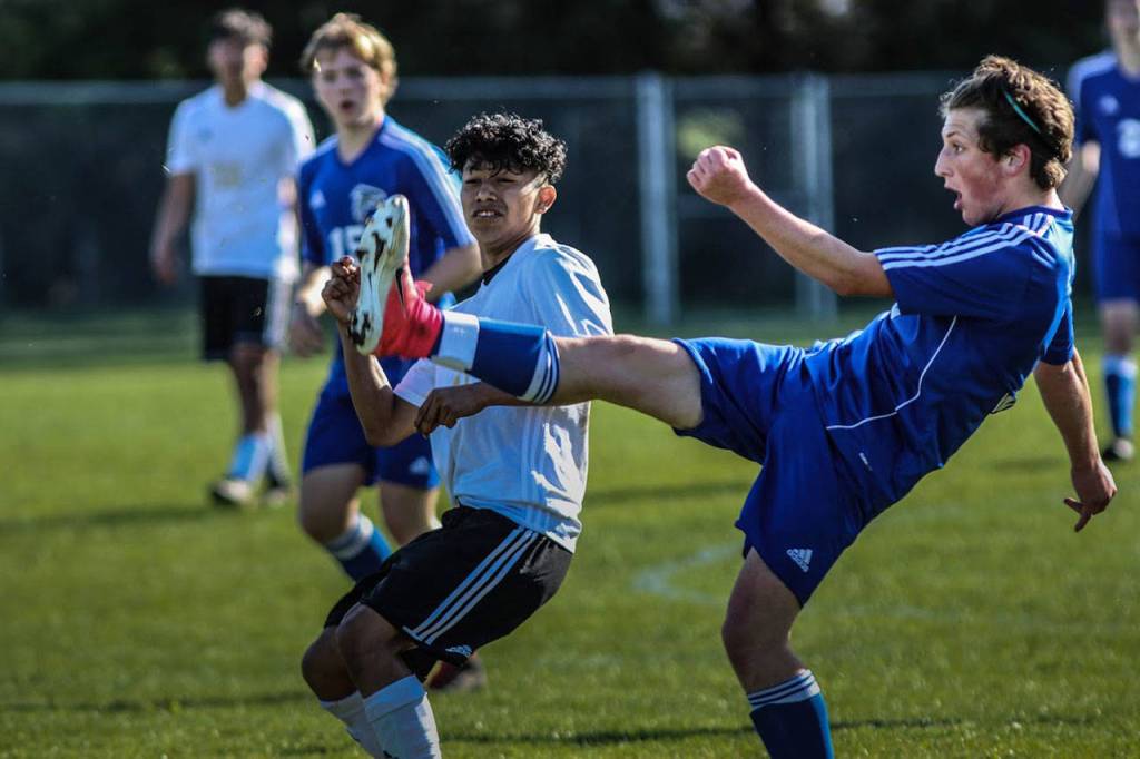 Cormac Workman clears the ball for the Falcons.(Photo by Matt Simms)