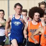 Callanhan Yale (blue jersey) runs with the pack in the 1,600.(Photo by Matt Simms)