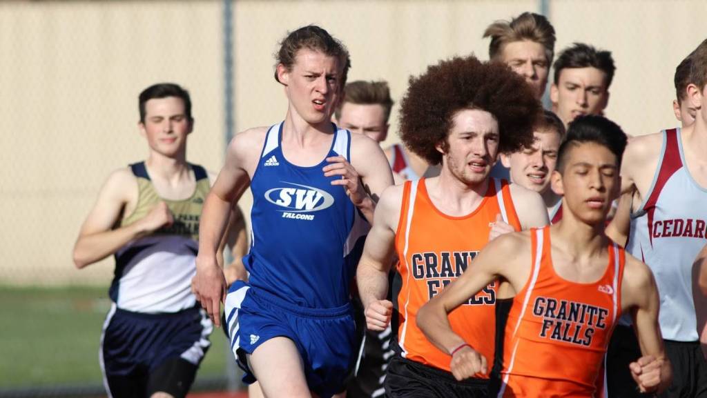 Callanhan Yale (blue jersey) runs with the pack in the 1,600.(Photo by Matt Simms)