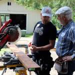 Andy Ruggenberg (left) and his father, Tim, consult about the ramp they helped build at a Freeland home Saturday. The entire family of Griffin Ruggenberg worked at the South Whidbey Hearts & Hammers home site where Griffin was to be team leader. Co-owner of Island Construction and father of three young daughters, Griffin Ruggenberg recently died in an accident at age 37. Photos by Patricia Guthrie/Whidbey News Group