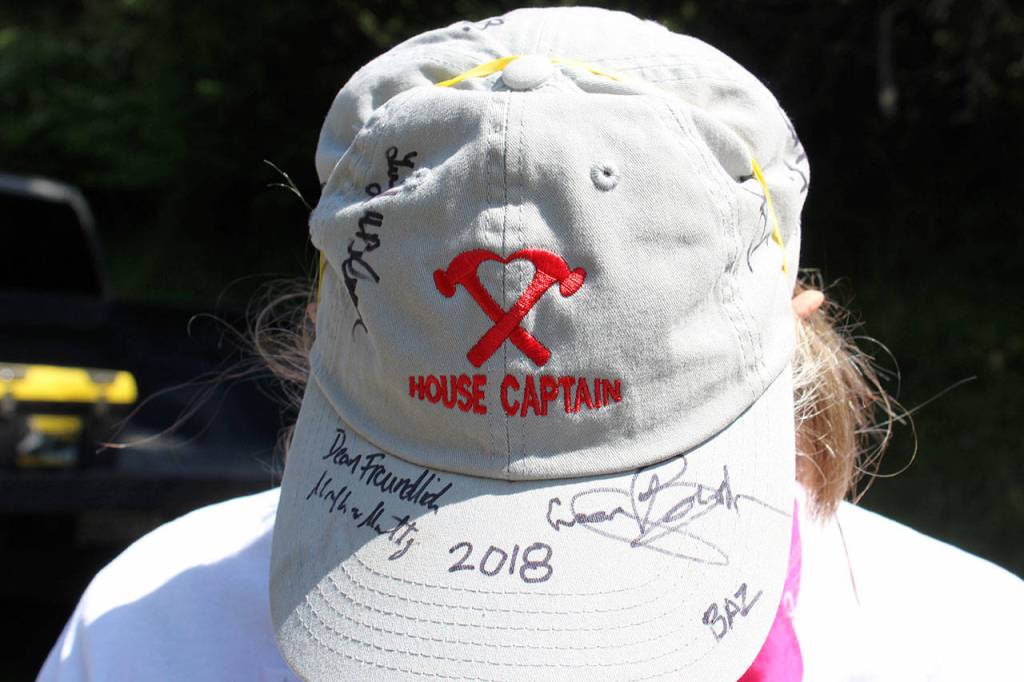 Every year, Ashley McConnaughey has fellow volunteers sign her Hearts & Hammers House Captain hat. More than 400 people volunteered on Saturday and many attended that evenings 25th anniversary celebration dinner.