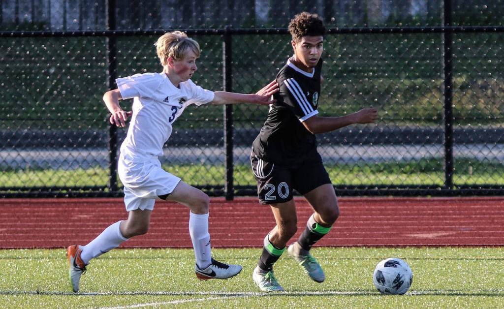 Thomas Simms fights a Klahowya player for possession.(Photo by Matt Simms)