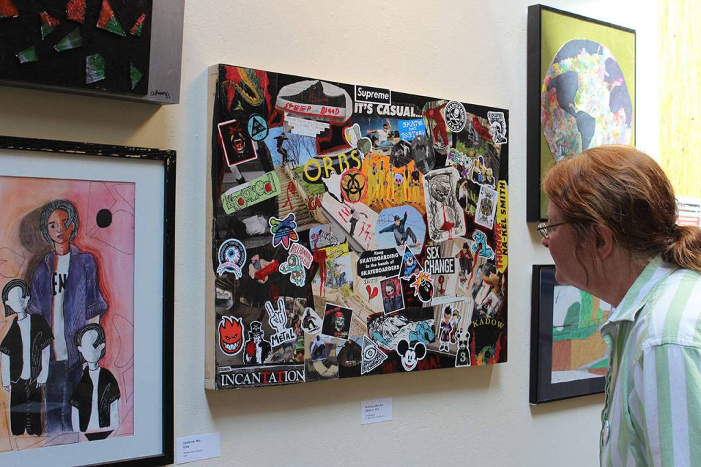 Marian Myszkowski, program and fund director of Goosefoot, looks over some of the pieces hanging on both floors of the Hub gallery in the Bayview Cash Store. The show is up until June 11. Photos by Patricia Guthrie/Whidbey News Group