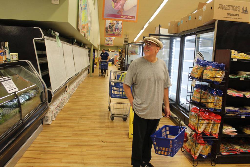 Goose shopper Rick Knight wonders why the deli case is empty as he looks for milk and yogurt Monday afternoon. Where did they put everything? he asked.