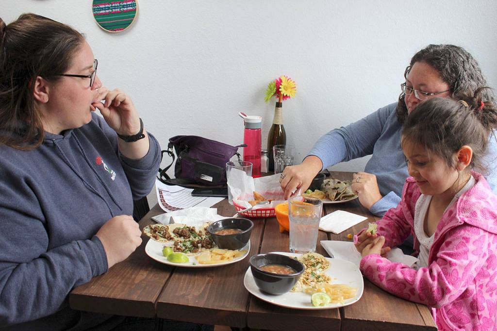 Carolyn Schultz (left) has lunch with Elena Lindsey, 5, and Carson Allen at Molka Xete. The Oak Harbor residents decided to stop in the Greenbank restaurant for the first time after taking their dogs to Double Bluff beach. Photo by Patricia Guthrie/Whidbey News Group