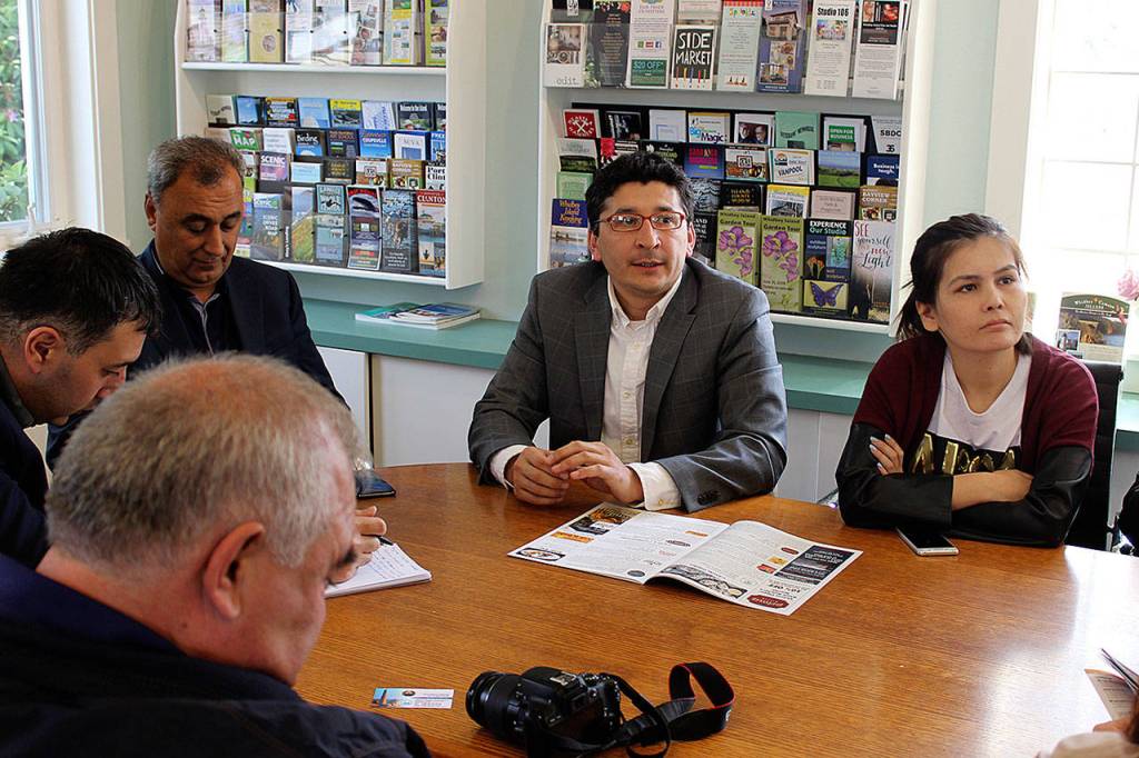 Translator Elmurad Kasym, center, helped government officials learn how Langley markets itself. Although he speaks English, Uzbek, Russian and Turkish, some Whidbey Island concepts just didnt translate, such parades for whales.