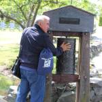 Erkin Yakubov, the mayor of Khiva, Uzbekistan, spins a prayer wheel in a Langley park.