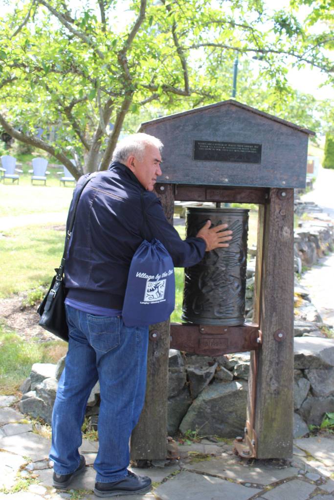 Erkin Yakubov, the mayor of Khiva, Uzbekistan, spins a prayer wheel in a Langley park.