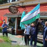 The flag of Uzbekistan flying from Music for the Eyes store greeted visitors from the Central Asia country. The delegates visited Langley as part of an Open World program to learn about tourism. Photo by Patricia Guthrie/Whidbey News Group