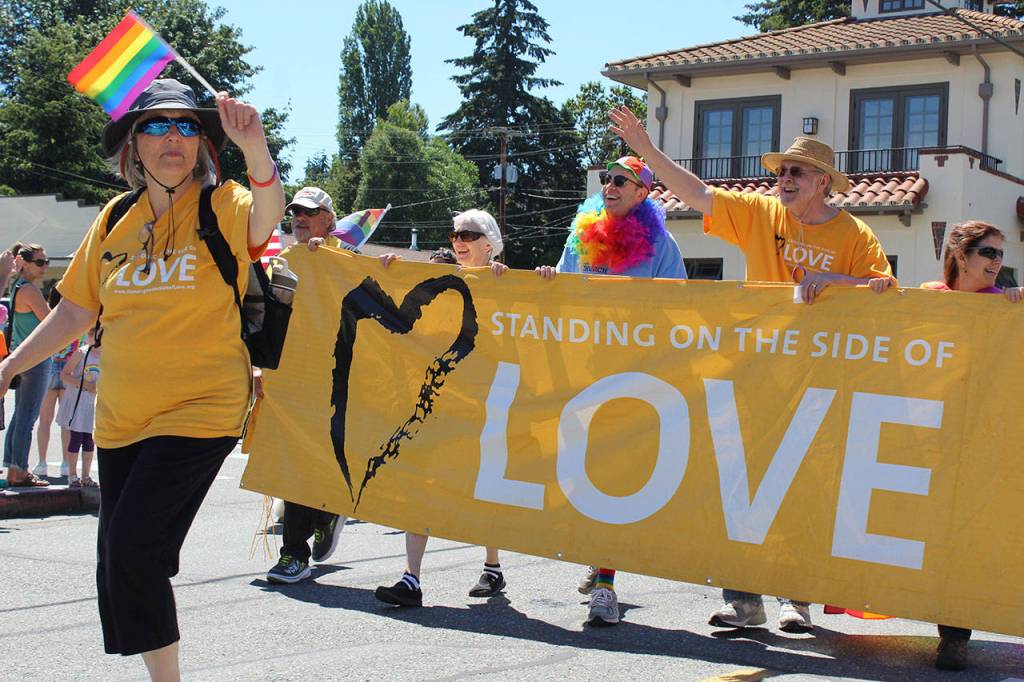 Members of Freelands Unitarian Universalist Congregation of Whidbey Island carry a banner expressing their sentiment about acceptance.