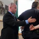 Consultant Glen Carpenter asked Langley Police Chief David Marks to help demonstrate handcuffing protocol and other arresting techniques during his 90-minute presentation about excessive use 0f force allegations against Marks. Photo by Patricia Guthrie/Whidbey News Group