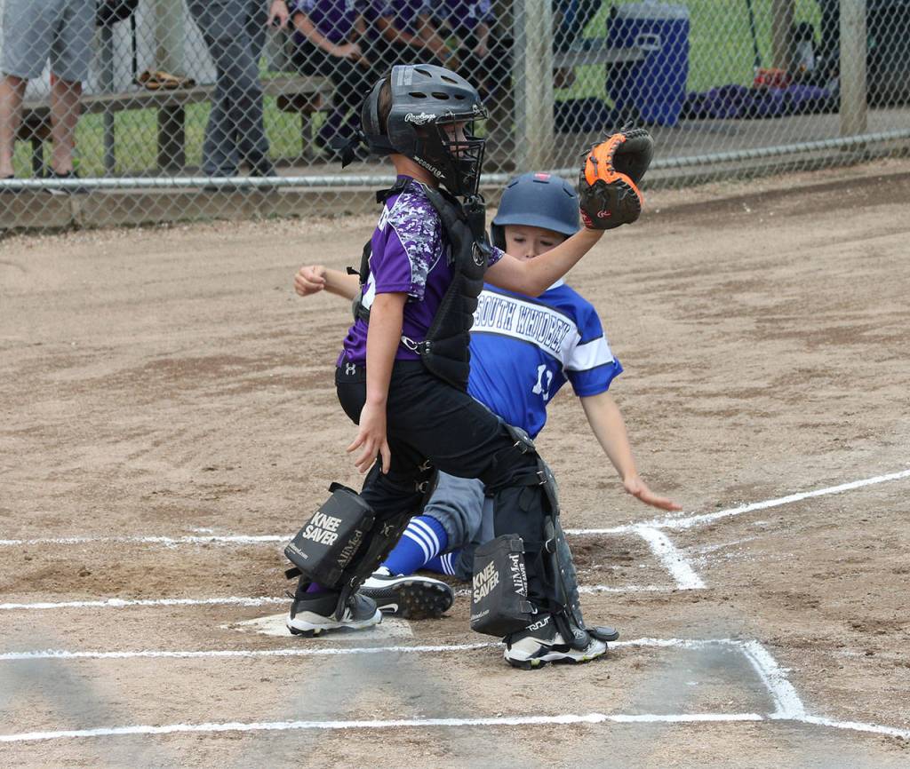 Matthew Tarantino scores a run for South Whidbey against Anacortes as catcher Max Nibarger awaits the throw.(Photo by Jim Waller/South Whidbey Record)