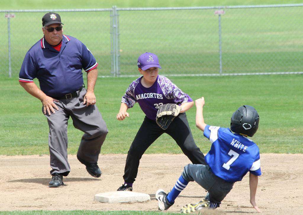 Kowen White safely slides into second base in the Anacortes game.(Photo by Jim Waller/South Whidbey Record)