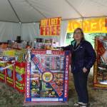 Sarah Szpak stands by the ultra big boxes of fireworks for sale at Big Dog Fireworks in Freeland. Since the tent opened Friday morning, Szpak said theres been a steady stream of customers spending an average of $50.