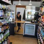 Emily Terao cleans up the small kitchen in the Greenbank Pantry and Deli that opened Thursday. It sells basic household items as well as wines, deli meats and cheeses, a variety of other food and freshly-made salads and sandwiches. Photo by Patricia Guthrie/Whidbey News Group