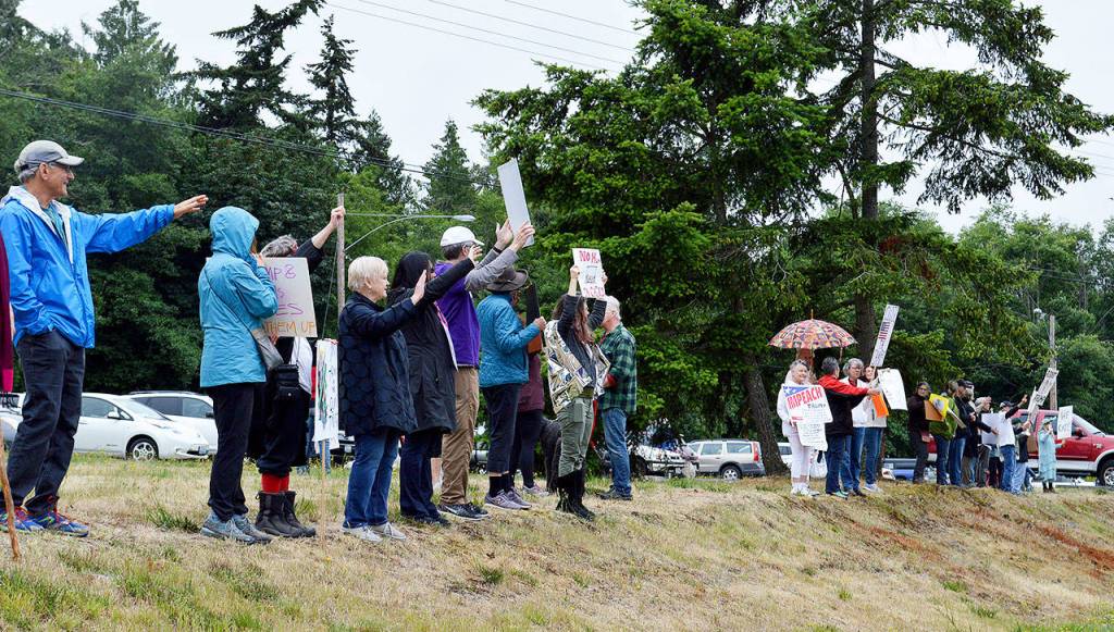 Around 200 protesters gathered Saturday morning at the Bayview Park and Ride, joining over 700 other Families Belong Together rallies across the country. Photo by Laura Guido/Whidbey News Group