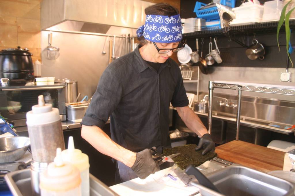 Photos by Emily Gilbert/Whidbey News Group.                                 Denis Zimmermann cuts nori (seaweed), a feature of many of the menu items at his restaurant. He opened Ultra House in May 2018 after a 25-year career in graphic design and advertising because he did not want to work behind a computer anymore.