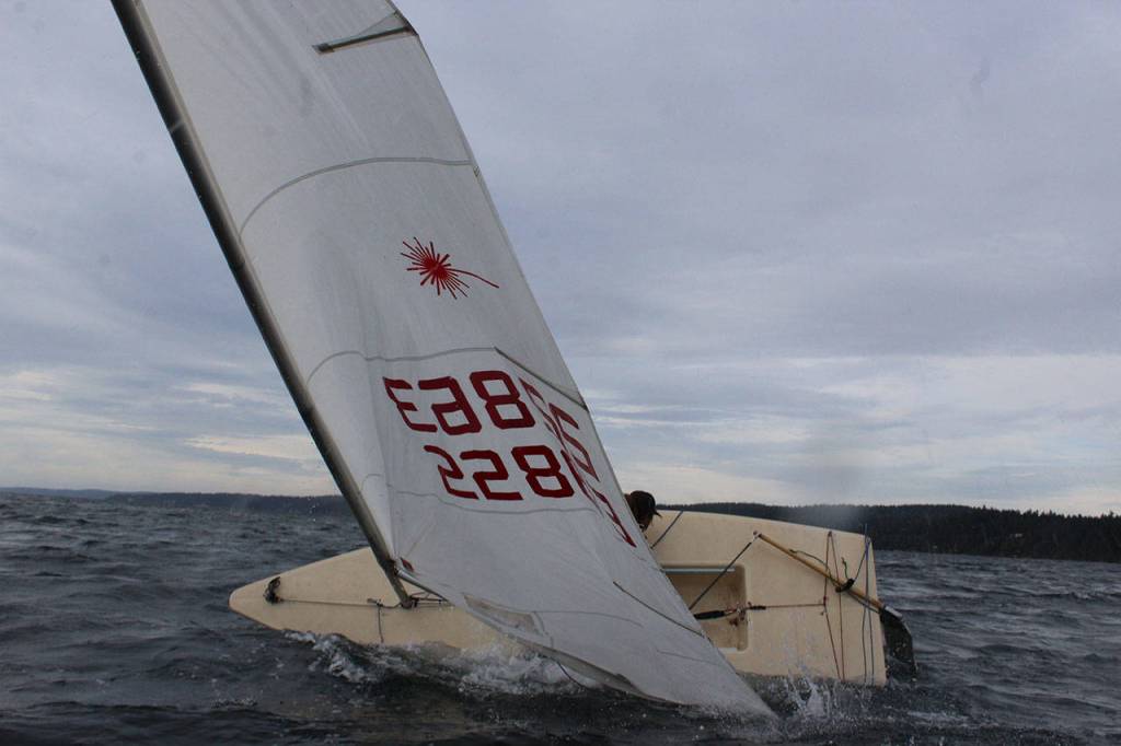 A safety boat is on patrol during all sailing races to help when boats capsize. Wearing wet suits is recommended in case sailors spend more time in the cold water than anticipated.